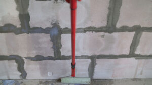 Roller,Application,Of,Waterproofing,Sealant,To,The,Wall.,Applying,A